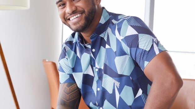 Tua Tagovailoa modeling a blue Perry Ellis shirt.